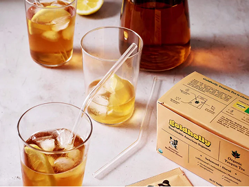 Goldholly Medium Roast Yaupon tea box beside iced tea in glasses with lemon slices